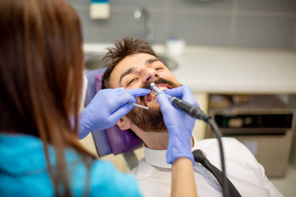 istock Female dentist drilling tooth to patient. 1320215698