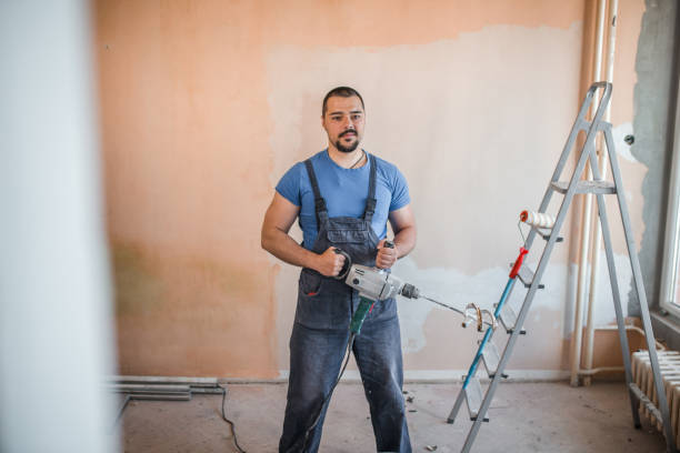 istock Handsome worker holding paint mixing machine 1320215750