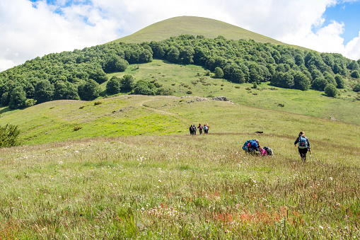 Monti Sibillini, Umbria, Italy - June 02, 2020: Leave the Canapine Forks behind to walk into Monte Guaidone. From this perspective, we have on the left the great plan of Castelluccio, while on the right there is the whole Marche region.