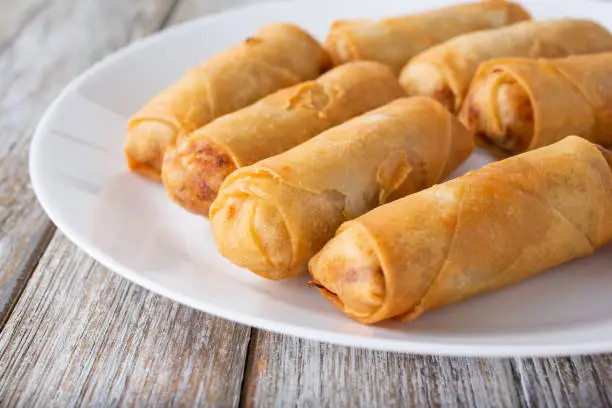 A closeup view of a plate of egg rolls.