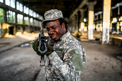 Portrait of armed soldier on mission in abandoned building