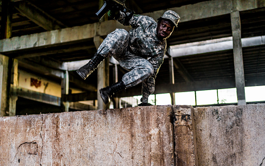 Armed soldier on a mission in a ruined building