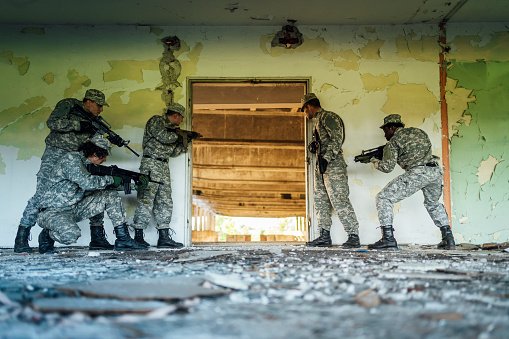 Soldiers with rifles in a tactical position during the military operation