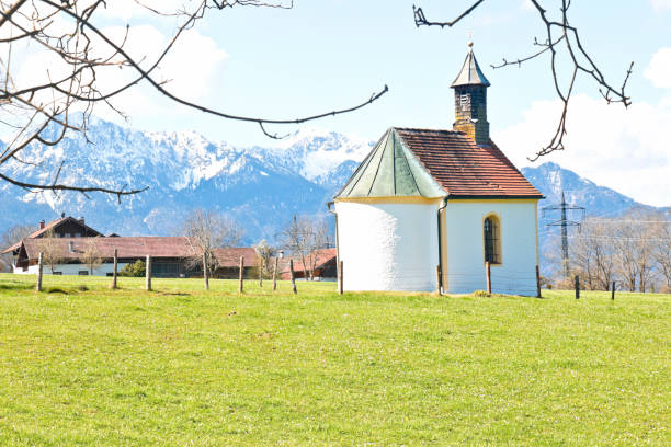 istock Small chapel with a view of snowcapped mountains in spring 1320218050