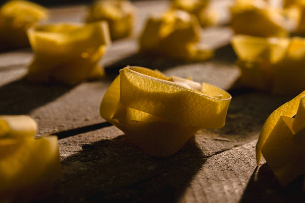 Dry pasta on a floured wooden surface.