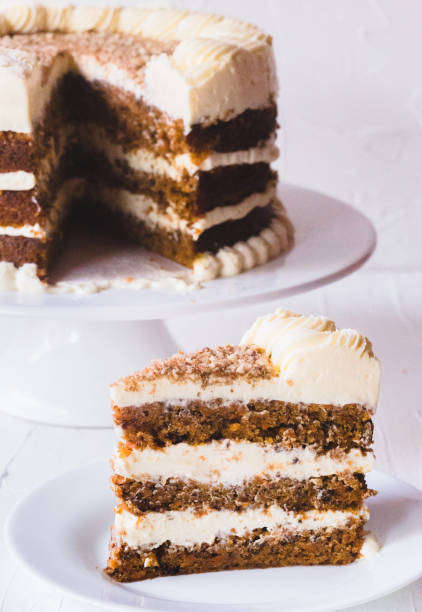 istock Carrot cake and slice on a white plate and white background. 1320219080