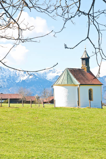 istock Small chapel in spring with snowcapped mountains 1320219121
