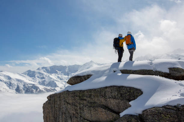 istock Mountaineers pause on snowy summit and look out 1320219990