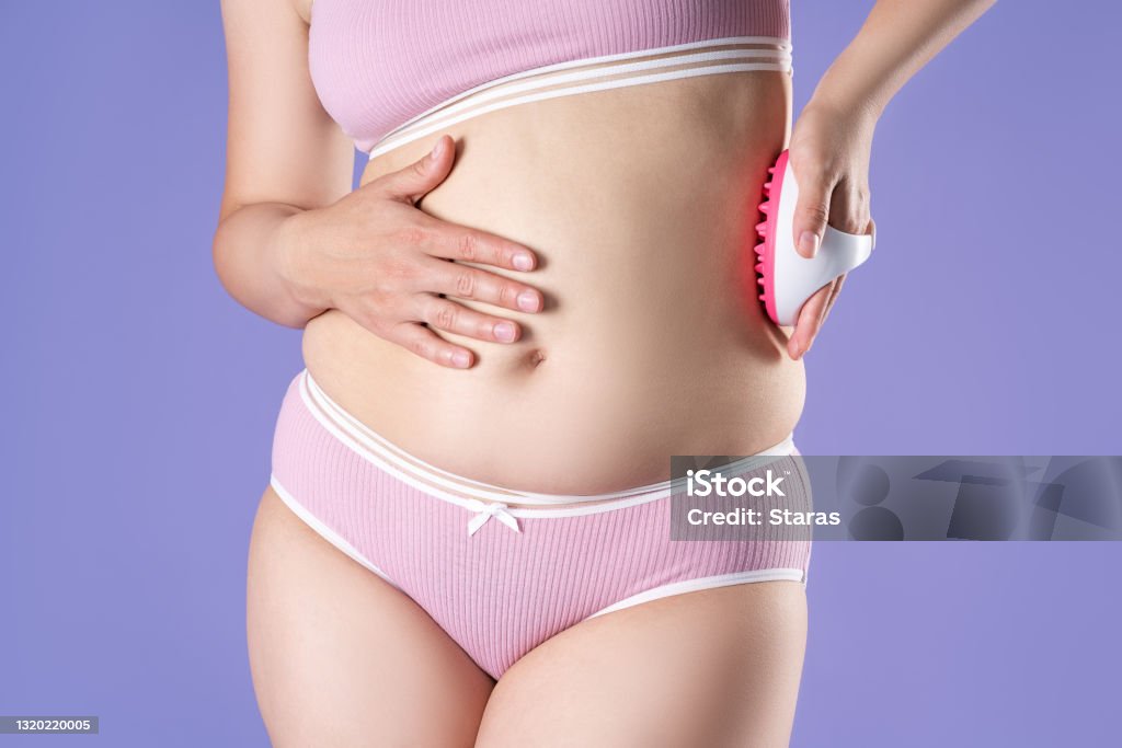 Woman Massaging Belly With Massage Brush On Purple Background Stock ...