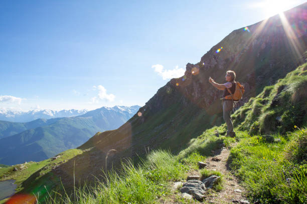 istock Hiker takes photo on sunny mountain ridge 1320221214