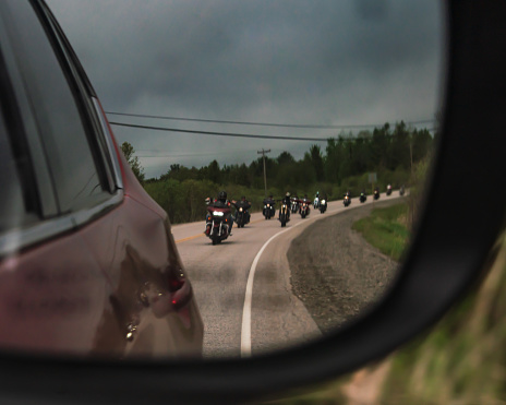 Group of Bikers in side Mirrors of a Car