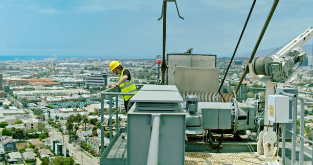 istock Construction Worker Looks Down from Top of a Crane 1320223589