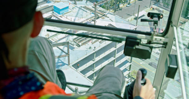 istock Portrait of A Crane Operator At Work with City Far Below 1320223597