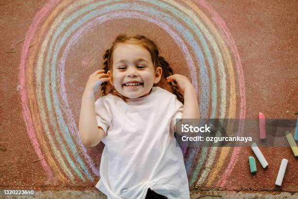 Child Drawing Rainbow With Chalk Stock Photo - Download Image Now - Child, Chalk - Art Equipment, Chalk Drawing