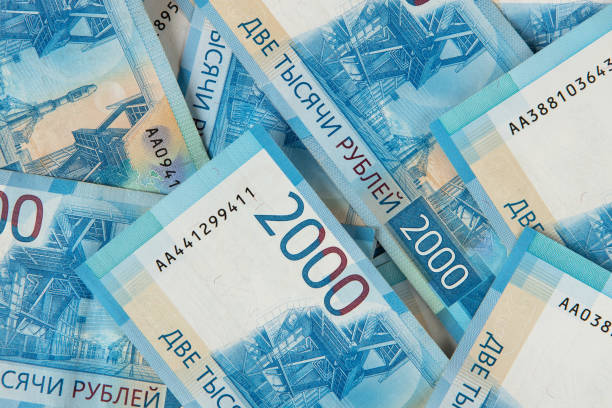 istock Background from Russian money, many banknotes rubles, denomination 2000, close-up. Concept of cash, salary, loan, wealth, sweet life, credit, finance, business, deposit, insurance. Top view, flat lay 1320224214