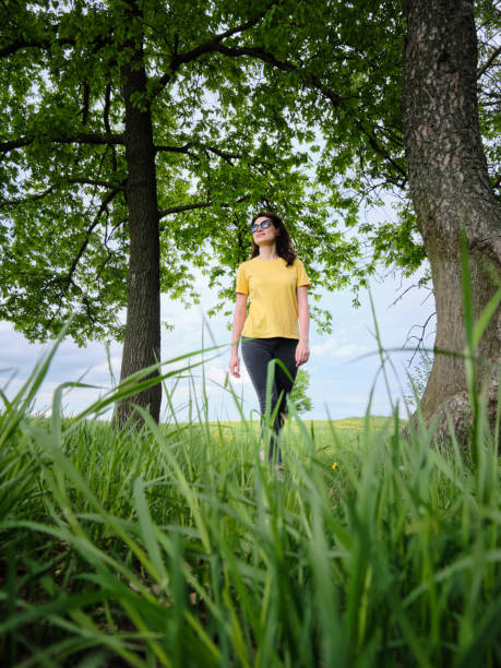 istock woman walks along a path on a sunny day 1320224461