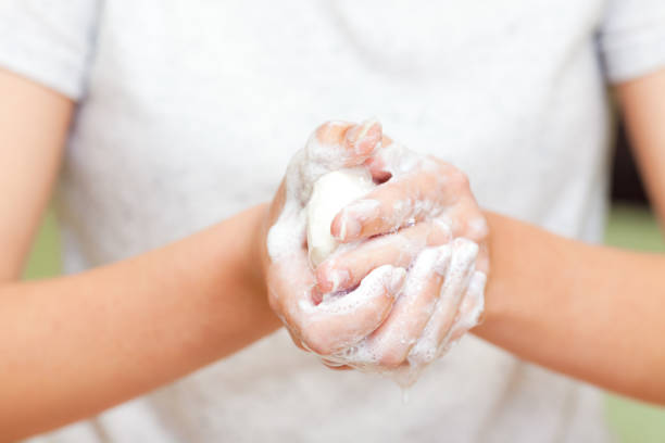 istock Front view on girls hands with soap foam 1320224541