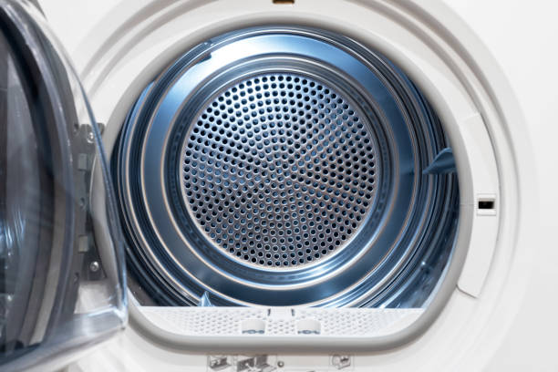 View inside of a clothes dryer, close up. Empty stainless steel tumble dryer. View inside of a clothes dryer, close up. Empty stainless steel tumble dryer. tumble dryer stock pictures, royalty-free photos & images