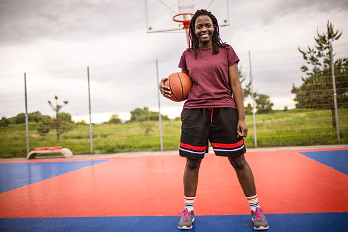 Photo of Young African American woman at the basketball court