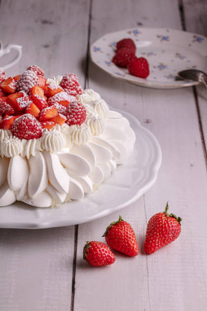 istock Red fruit pavlova with a cup of tea 1320226298