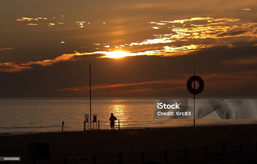 Golden sunset Beach scene at dusk Beach scene at dusk Back Lit Stock Photo