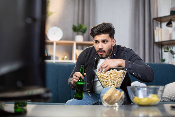 istock Young muslim man watching soccer match on television 1320229479