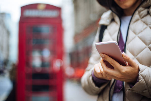 istock Cute woman in London using smartphone 1320230171