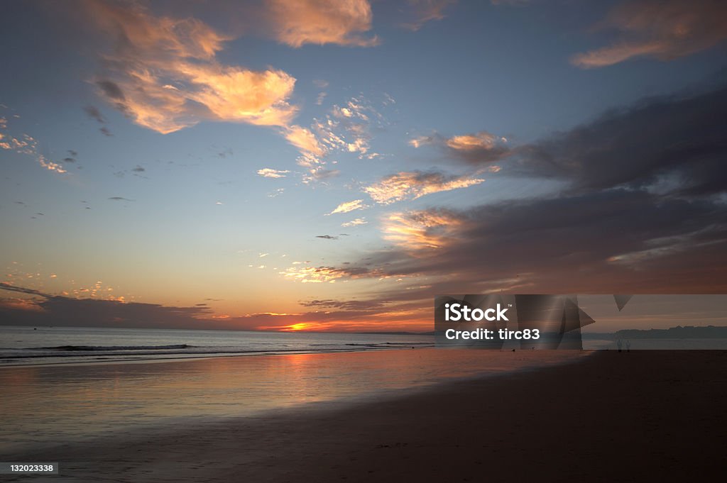 Beach scene at dusk fiery sunset Beach scene at dusk Beach Stock Photo