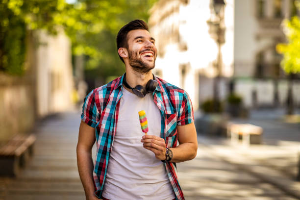 Charm Young Adult eating ice-cream on the street