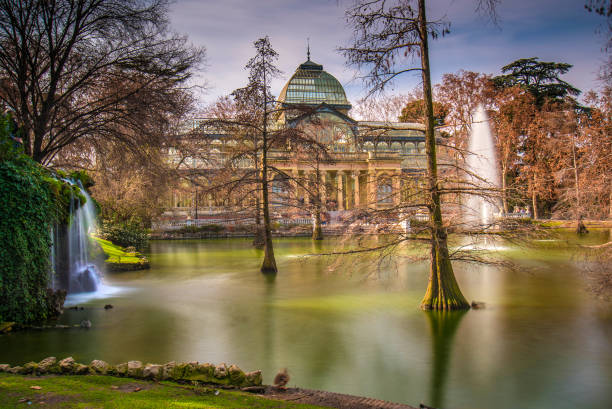 Crystal Palace in el Retiro Park, Madrid Spain The Crystal Palace was built in 1887 for the Philippine Islands Exposition, held that same year. Contemporary art exhibitions are currently being held there. It is located in El Parque del Buen Retiro, also known as El Retiro; It is a historical garden and public park located in Madrid, the capital of Spain. It is one of the main tourist attractions in the city, and houses numerous architectural, sculptural and landscape ensembles from the 17th to 21st centuries. palacio de cristal photos stock pictures, royalty-free photos & images