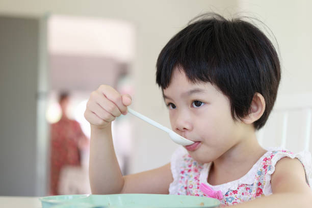 istock Little asian girl having breakfast 1320240082