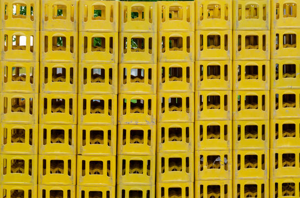 istock Yellow Stackable Plastic Bottle Boxes. Lots of empty used glass container crates. 1320240205
