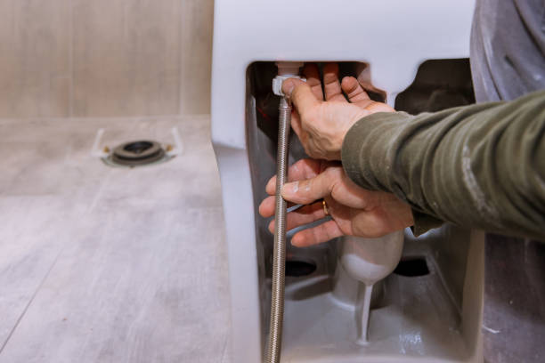istock Construction worker installing a new white bidet in a bathroom 1320241803