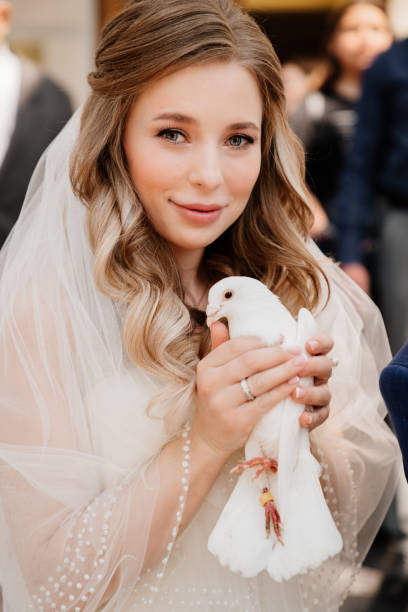 istock The bride is holding a pair of white pigeons. 1320241832