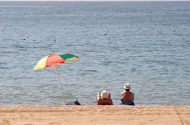 istock Couple on beach with parasol 132024535