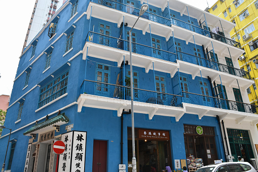 Hong Kong, China - August 10, 2019: The Blue House on Stone Nullah Lane in Wan Chai, one of the last surviving wooden tenement buildings (tong lau) in the city, which also houses the House of Stories, a museum.