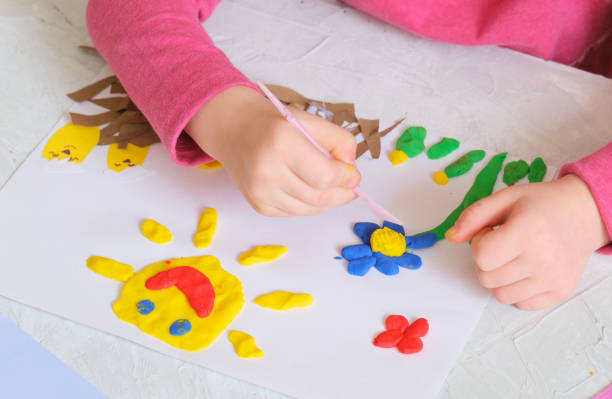 istock Child making spring card from colorful paper and clay. Handmade. 1320249043