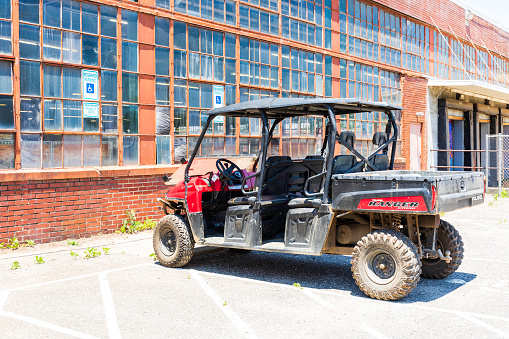 Charlotte, NC, USA-23 May 2021: Camp North End. Polaris Ranger Crew vehicle parked at old industrial building.