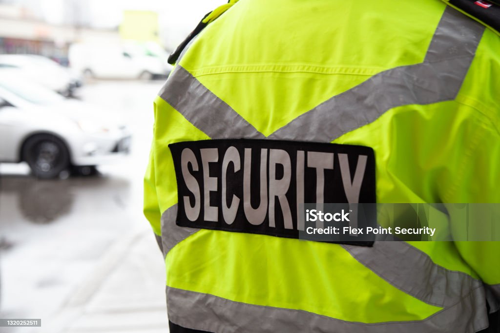 Security guard. Watching over parking area Security guard. Watching over the parking area. The security guard is protecting property from illegal parking and theft. Security Guard Stock Photo