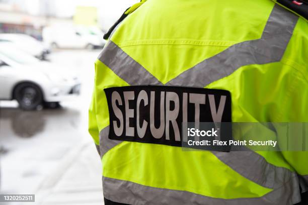 Security Guard Watching Over Parking Area Stock Photo - Download Image Now - Security Guard, Parking Lot, Responsibility