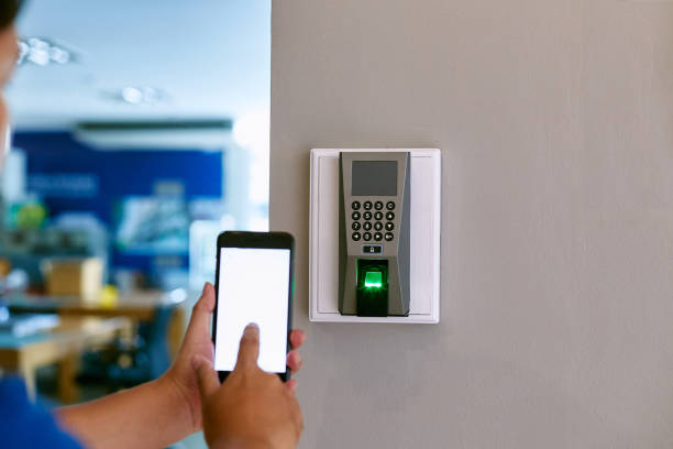 istock Digital door lock systems control by mobile phone for access security and protection. Man or woman user mobile for access digital door lock systems. Selective focus. 1320258483