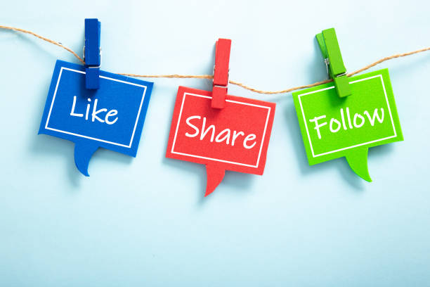 istock Like share follow bubble with clip hanging on the line with blue background. 1320261031