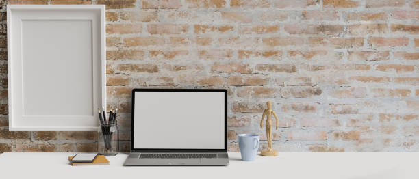 istock Computer laptop with mock-up screen in contemporary workspace with stationery and mock-up frame, 3D rendering 1320263528