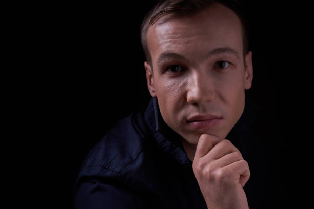 istock Beautiful young guy on a black background in the Studio 1320263530