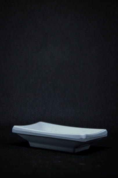 Square chinaware plate isolated on black