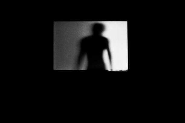 istock man shadows with Frosted glass 1320266806