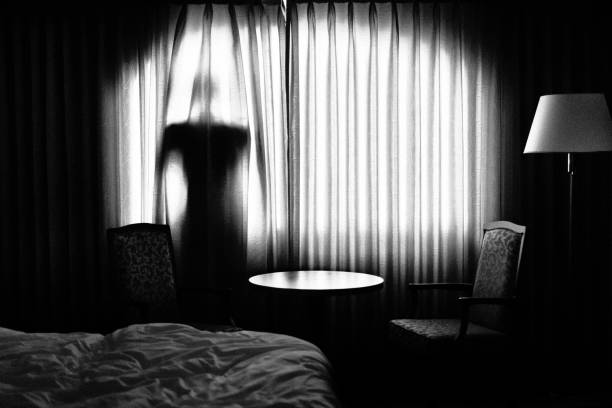 Man behind a curtain back Man behind a curtain back creepy stalker stock pictures, royalty-free photos & images
