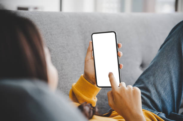 istock Woman using mobile smartphone and device white screen empty space smart phone, clipping path included 1320268783