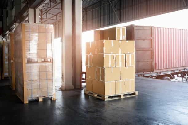 istock Stacked of Package Boxes Load into Cargo Container. Truck Parked Loading at Dock Warehouse. Delivery Service. Shipping Warehouse Logistics. Shipment Freight Truck Transportation. 1320272505