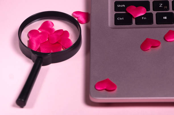 istock Red heart on the computer keyboard, magnifying glass with handle. 1320272812
